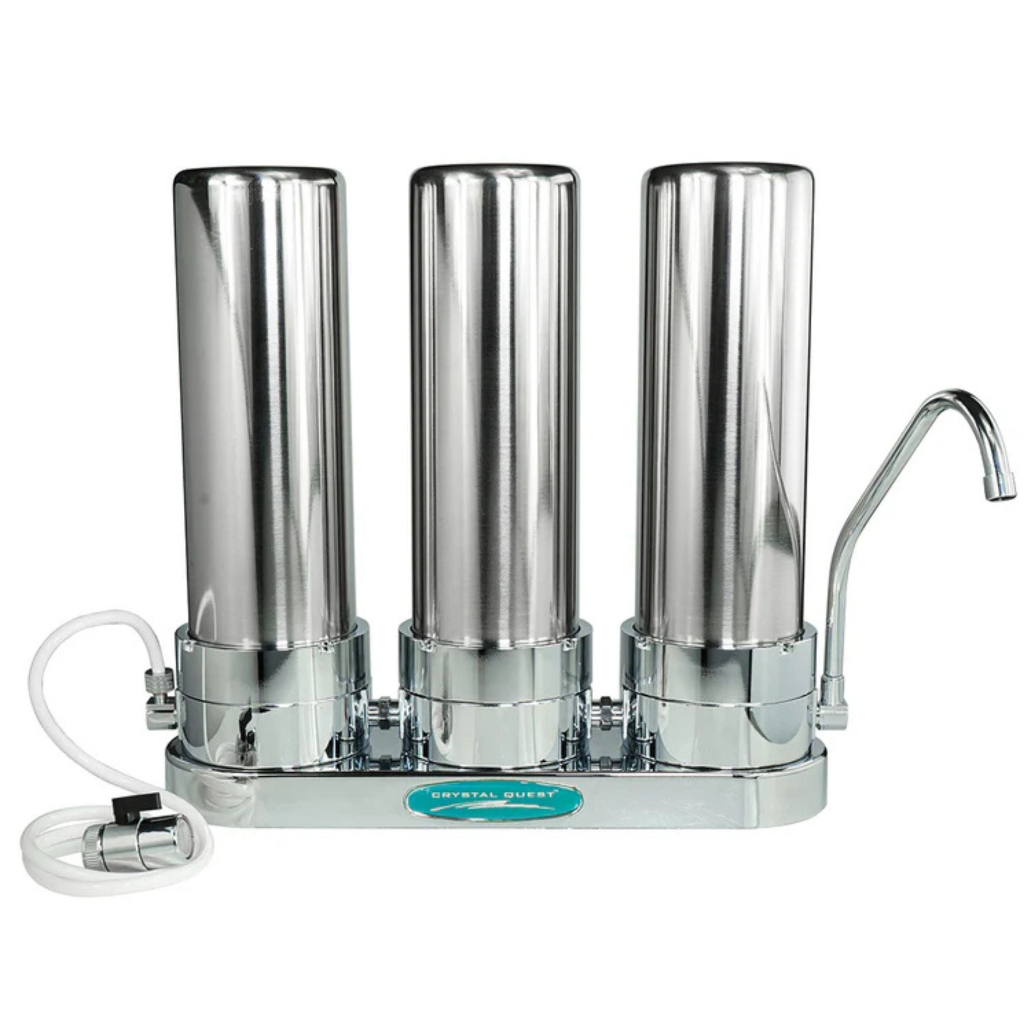 A three-cartridge stainless steel water filter pitcher with a curved metal spout, shown on a plain white background. A white plastic supply tube is attached to the left side, and a small teal label on the front reads 'STAINLESS STEEL'.